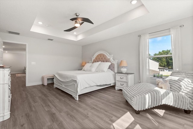 2340 Standing Rock Cir, Oakland, FL 34787 - bedroom with a raised ceiling, wood finished floors, recessed lighting, a ceiling fan, and baseboards