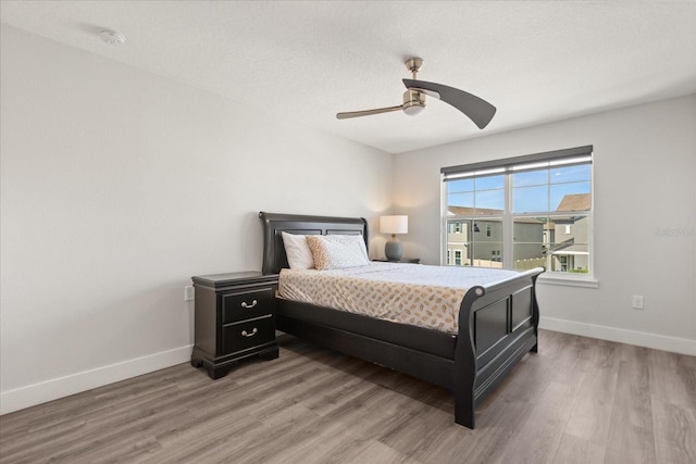 2340 Standing Rock Cir, Oakland, FL 34787 - bedroom with light wood-style floors, baseboards, and a ceiling fan