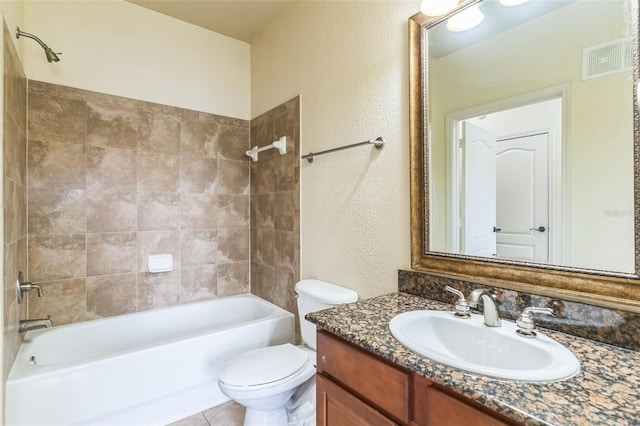 909 Charo Pkwy Unit 1011, Davenport, FL 33897 - bathroom with vanity, shower / tub combination, toilet, and a textured wall