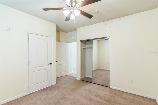 909 Charo Pkwy Unit 1011, Davenport, FL 33897 - unfurnished bedroom featuring light colored carpet, a closet, baseboards, and ceiling fan