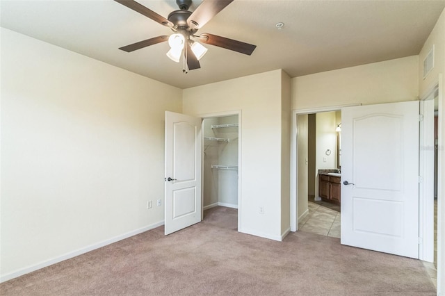 909 Charo Pkwy Unit 1011, Davenport, FL 33897 - unfurnished bedroom with light colored carpet, baseboards, a closet, a spacious closet, and ceiling fan