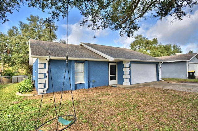 7504 Willow Wisp Dr E, Lakeland, FL 33810 - view of front of home with a garage, stucco siding, driveway, and roof with shingles