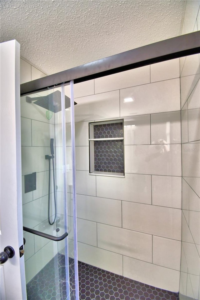 7504 Willow Wisp Dr E, Lakeland, FL 33810 - full bath with a stall shower, a textured ceiling, and tile patterned floors