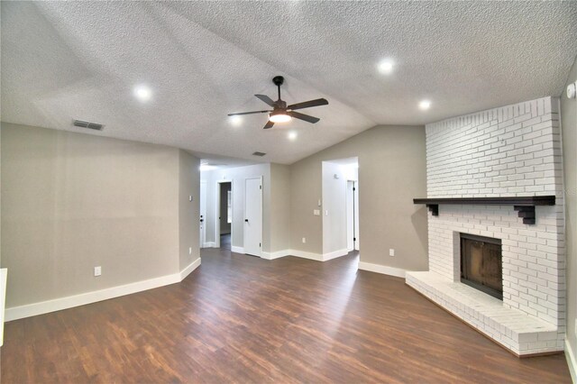 7504 Willow Wisp Dr E, Lakeland, FL 33810 - unfurnished living room featuring wood finished floors, a ceiling fan, a brick fireplace, baseboards, and a textured ceiling
