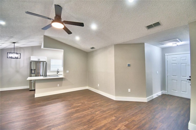 7504 Willow Wisp Dr E, Lakeland, FL 33810 - unfurnished living room with dark wood-style flooring, a ceiling fan, a textured ceiling, baseboards, and a sink