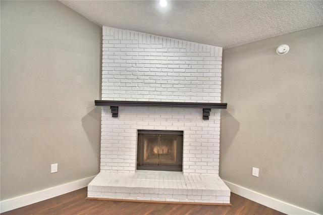 7504 Willow Wisp Dr E, Lakeland, FL 33810 - detailed view of wood finished floors, a textured ceiling, baseboards, a smoke detector, and a brick fireplace