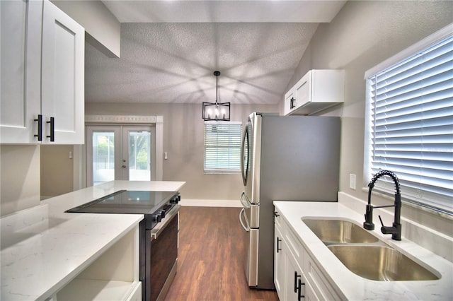 7504 Willow Wisp Dr E, Lakeland, FL 33810 - kitchen with a sink, appliances with stainless steel finishes, french doors, white cabinetry, and dark wood-style flooring