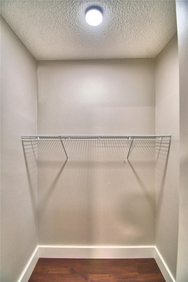 7504 Willow Wisp Dr E, Lakeland, FL 33810 - walk in closet featuring wood finished floors
