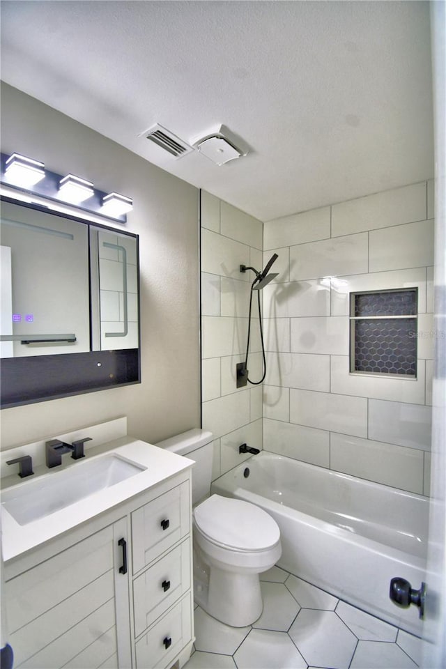7504 Willow Wisp Dr E, Lakeland, FL 33810 - bathroom with vanity, bathtub / shower combination, toilet, tile patterned floors, and a textured ceiling