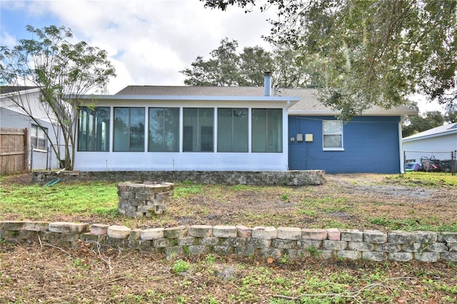 7504 Willow Wisp Dr E, Lakeland, FL 33810 - rear view of house with a sunroom and roof with shingles