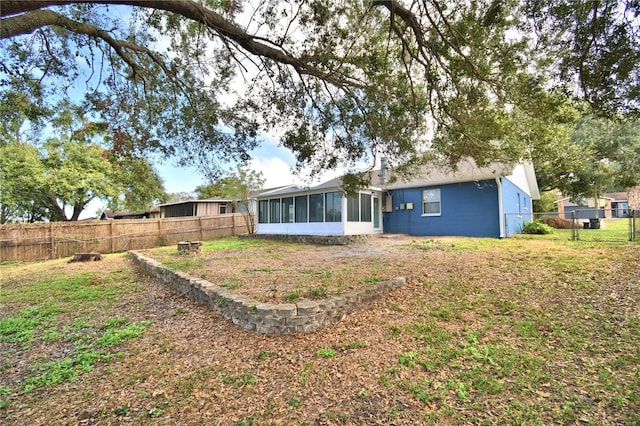 7504 Willow Wisp Dr E, Lakeland, FL 33810 - rear view of property featuring a sunroom