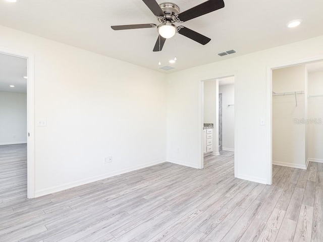 3124 N Chamberlain Blvd, North Port, FL 34286 - unfurnished bedroom featuring light wood-style flooring, baseboards, a spacious closet, a closet, and ceiling fan