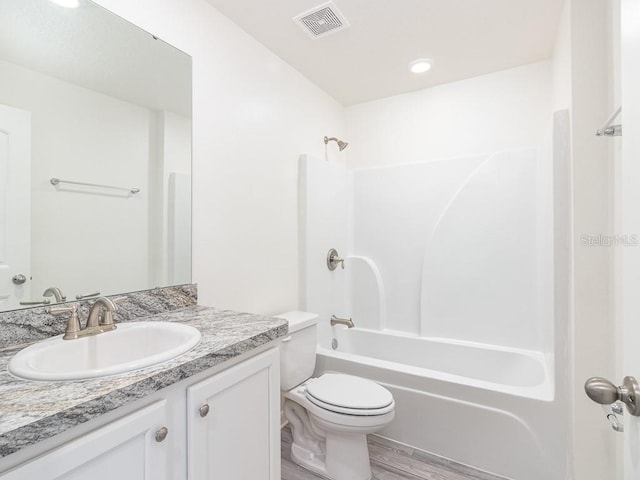 3124 N Chamberlain Blvd, North Port, FL 34286 - bathroom with vanity, toilet, shower / tub combination, and wood finished floors