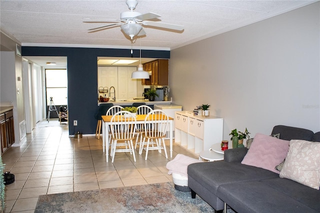 4364 White Pine Ave Unit 3, Orlando, FL 32811 - living room featuring ceiling fan, ornamental molding, light tile patterned floors, and a textured ceiling