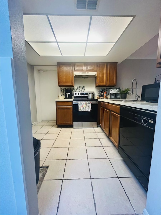 4364 White Pine Ave Unit 3, Orlando, FL 32811 - kitchen with electric stove, black dishwasher, under cabinet range hood, light countertops, and light tile patterned flooring