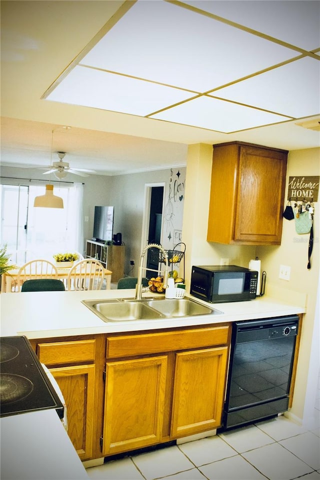 4364 White Pine Ave Unit 3, Orlando, FL 32811 - kitchen with black appliances, a sink, brown cabinets, light tile patterned floors, and light countertops