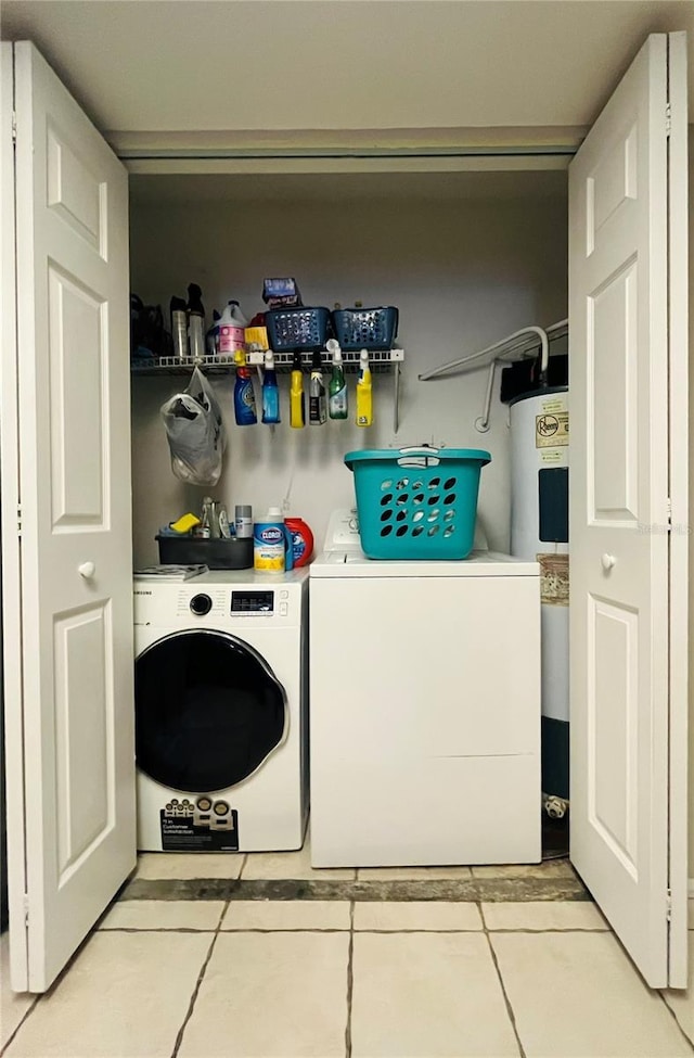 4364 White Pine Ave Unit 3, Orlando, FL 32811 - laundry room featuring washer and clothes dryer, electric water heater, and light tile patterned flooring