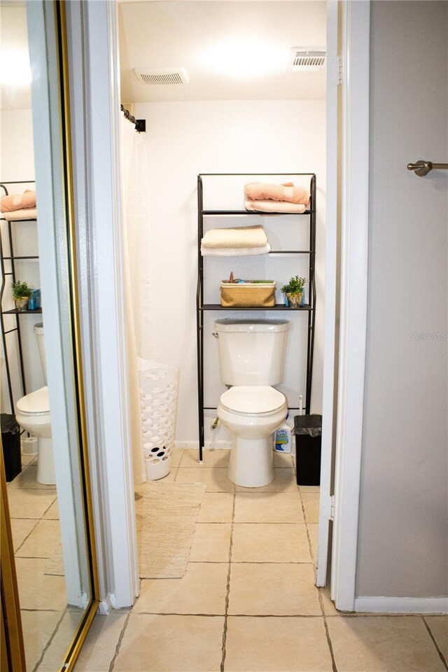 4364 White Pine Ave Unit 3, Orlando, FL 32811 - full bathroom with toilet, tile patterned floors, a shower with shower curtain, and baseboards