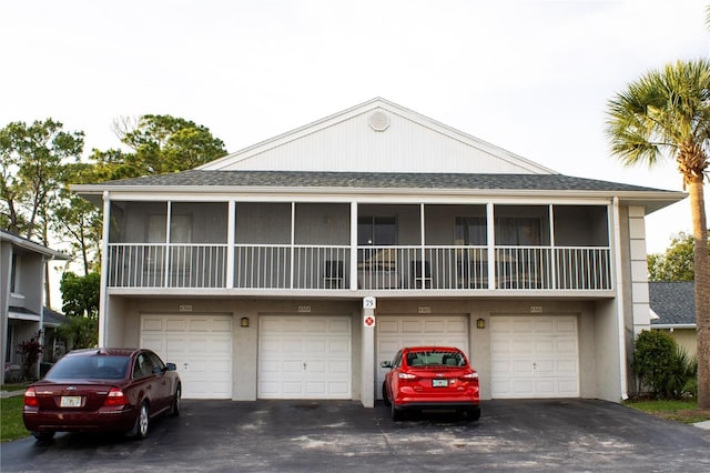 4364 White Pine Ave Unit 3, Orlando, FL 32811 - view of front of home featuring an attached garage, driveway, and roof with shingles