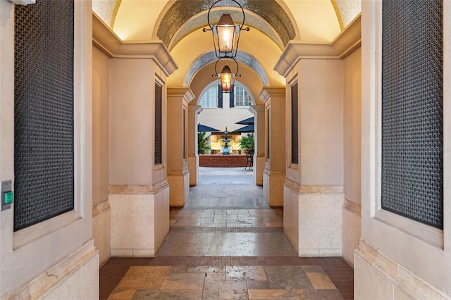 140 E Morse Blvd Unit J, Winter Park, FL 32789 - entryway with stone tile floors, arched walkways, ornate columns, vaulted ceiling, and crown molding