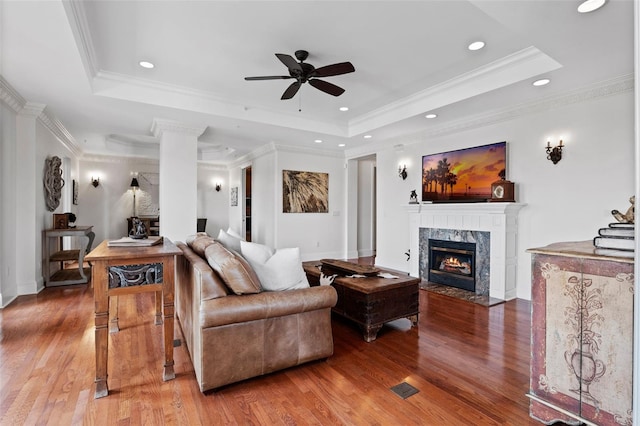 140 E Morse Blvd Unit J, Winter Park, FL 32789 - living room featuring ceiling fan, a tray ceiling, wood finished floors, a premium fireplace, and ornamental molding