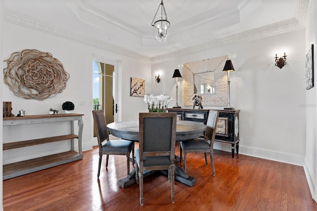 140 E Morse Blvd Unit J, Winter Park, FL 32789 - dining room featuring a tray ceiling, ornamental molding, wood finished floors, and baseboards