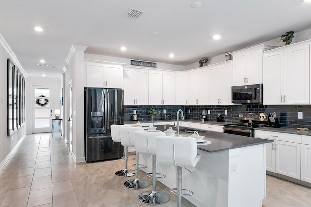 3004 Protagonist St, Kissimmee, FL 34746 - kitchen featuring refrigerator with ice dispenser, electric stove, stainless steel microwave, a sink, and decorative backsplash