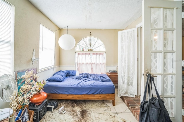 1711 E Sewaha St, Tampa, FL 33612 - tiled bedroom featuring a textured ceiling