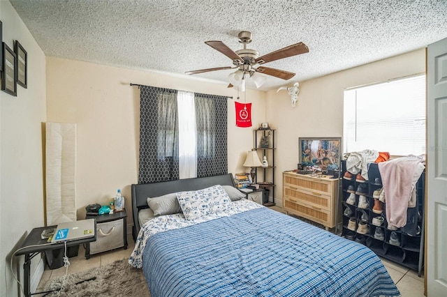 1711 E Sewaha St, Tampa, FL 33612 - bedroom featuring tile patterned floors, ceiling fan, and a textured ceiling
