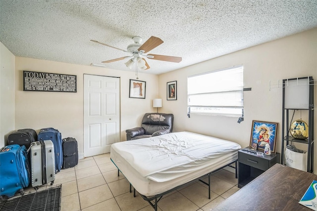 1711 E Sewaha St, Tampa, FL 33612 - bedroom with light tile patterned flooring, a textured ceiling, ceiling fan, and a closet
