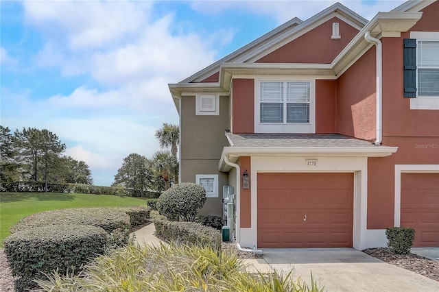 4178 SW 43rd Cir, Ocala, FL 34474 - townhome / multi-family property featuring stucco siding, a garage, and driveway