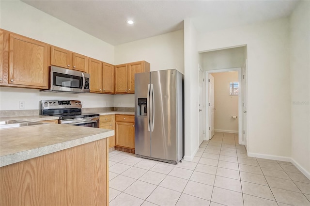 4178 SW 43rd Cir, Ocala, FL 34474 - kitchen featuring stainless steel appliances, light countertops, light tile patterned floors, and baseboards