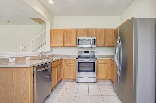 4178 SW 43rd Cir, Ocala, FL 34474 - kitchen with appliances with stainless steel finishes, a sink, light tile patterned floors, a peninsula, and light countertops
