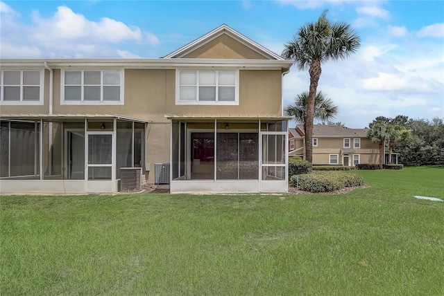 4178 SW 43rd Cir, Ocala, FL 34474 - back of house with a sunroom, a lawn, central AC, and stucco siding