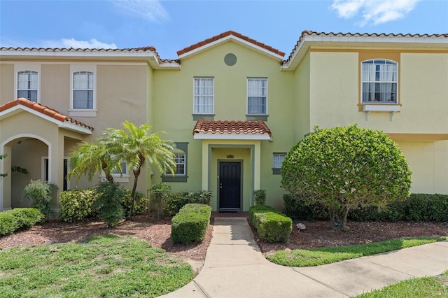 214 Monroe Cir, Davenport, FL 33896 - view of front of house featuring a tiled roof and stucco siding