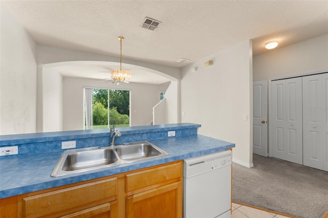 214 Monroe Cir, Davenport, FL 33896 - kitchen with dishwasher, a sink, arched walkways, light carpet, and a textured ceiling