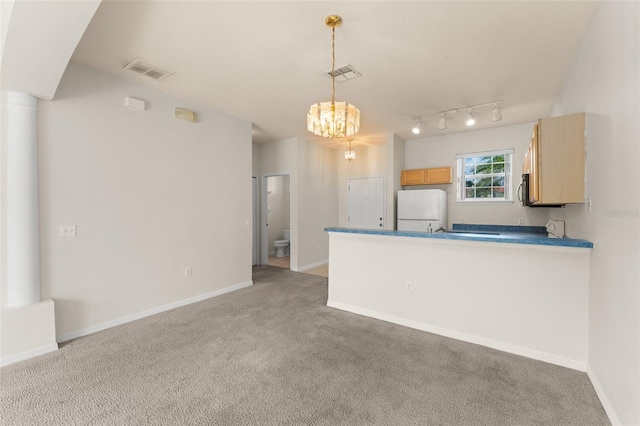 214 Monroe Cir, Davenport, FL 33896 - kitchen with freestanding refrigerator, light carpet, a chandelier, a peninsula, and baseboards