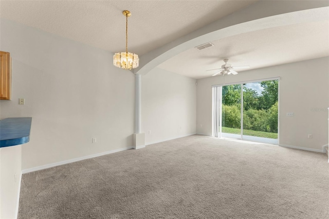 214 Monroe Cir, Davenport, FL 33896 - unfurnished room with a ceiling fan, arched walkways, carpet flooring, baseboards, and a chandelier