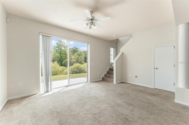 214 Monroe Cir, Davenport, FL 33896 - unfurnished living room with ceiling fan, carpet floors, stairs, a textured ceiling, and baseboards