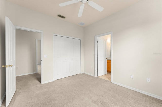 214 Monroe Cir, Davenport, FL 33896 - unfurnished bedroom with light carpet, a closet, baseboards, ceiling fan, and ensuite bathroom