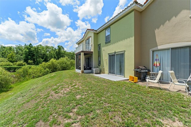 214 Monroe Cir, Davenport, FL 33896 - view of grassy yard with a balcony and a patio