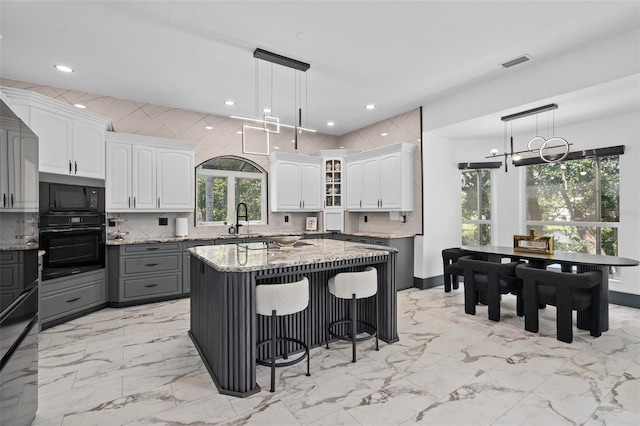 8131 Vineland Oaks Blvd, Orlando, FL 32835 - kitchen with oven, light marble finish flooring, a sink, and recessed lighting