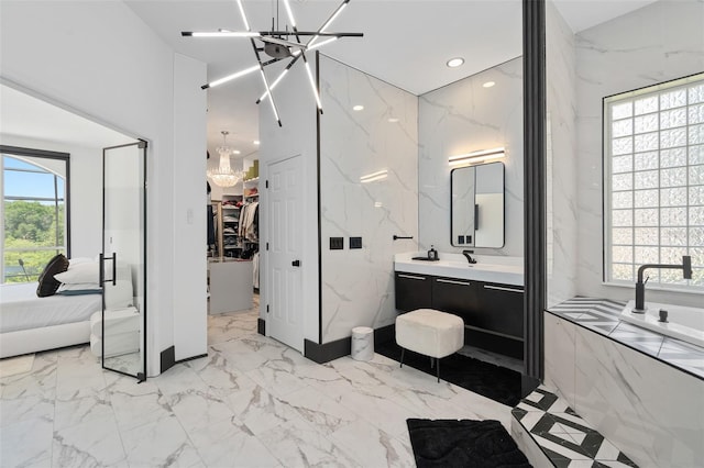 8131 Vineland Oaks Blvd, Orlando, FL 32835 - full bathroom with a chandelier, vanity, marble tiled flooring, connected bathroom, and recessed lighting
