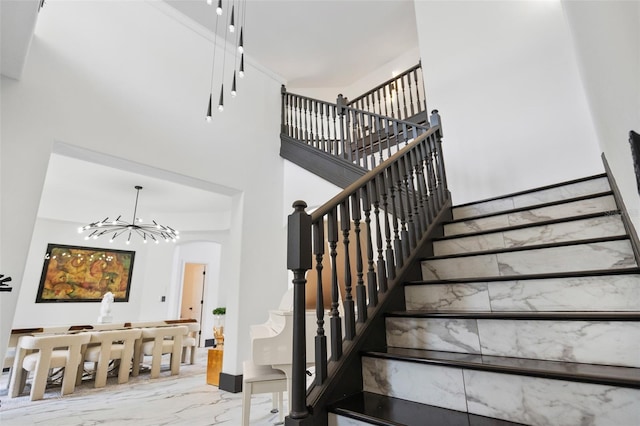 8131 Vineland Oaks Blvd, Orlando, FL 32835 - stairs featuring marble look tiles, a chandelier, arched walkways, and a high ceiling