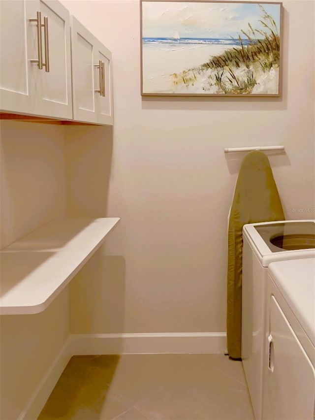 410 SE Vallarta Dr, Port St Lucie, FL 34984 - laundry area with washer and clothes dryer, cabinet space, baseboards, and light tile patterned floors