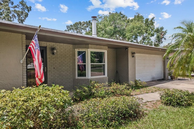 310 E Gulley Ave, Oakland, FL 34760 - single story home featuring brick siding, an attached garage, and concrete driveway