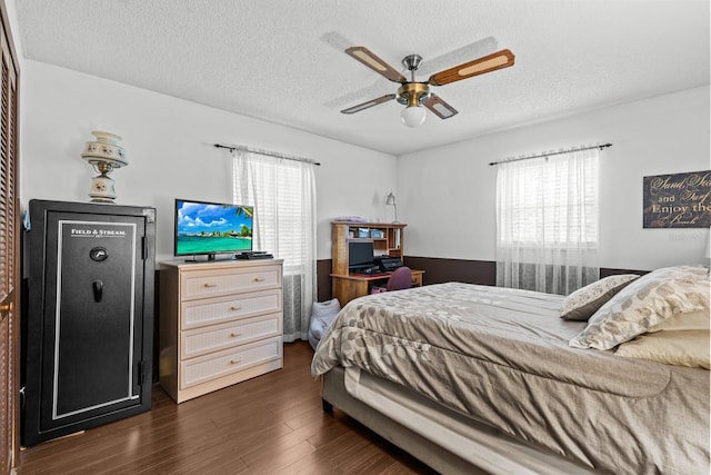 310 E Gulley Ave, Oakland, FL 34760 - bedroom with multiple windows, dark wood-type flooring, a textured ceiling, and a ceiling fan