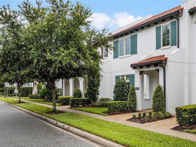 8818 Bismarck Palm Dr, Winter Garden, FL 34787 - view of front of property featuring a tiled roof and stucco siding