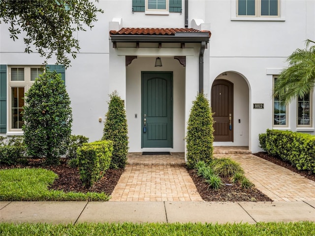 8818 Bismarck Palm Dr, Winter Garden, FL 34787 - doorway to property with stucco siding and a tiled roof