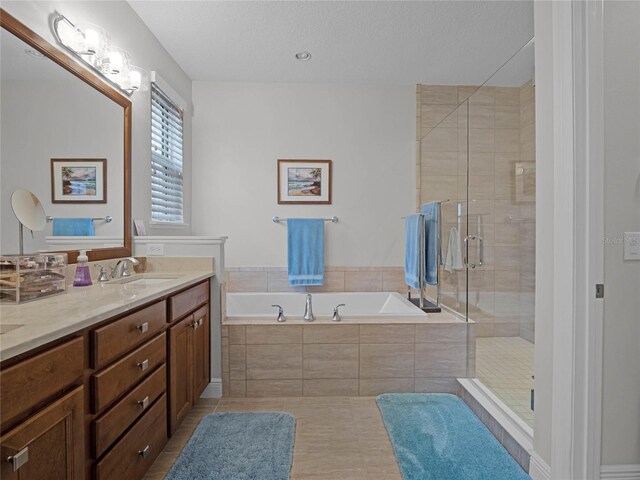8818 Bismarck Palm Dr, Winter Garden, FL 34787 - bathroom with double vanity, a bath, a stall shower, and tile patterned flooring